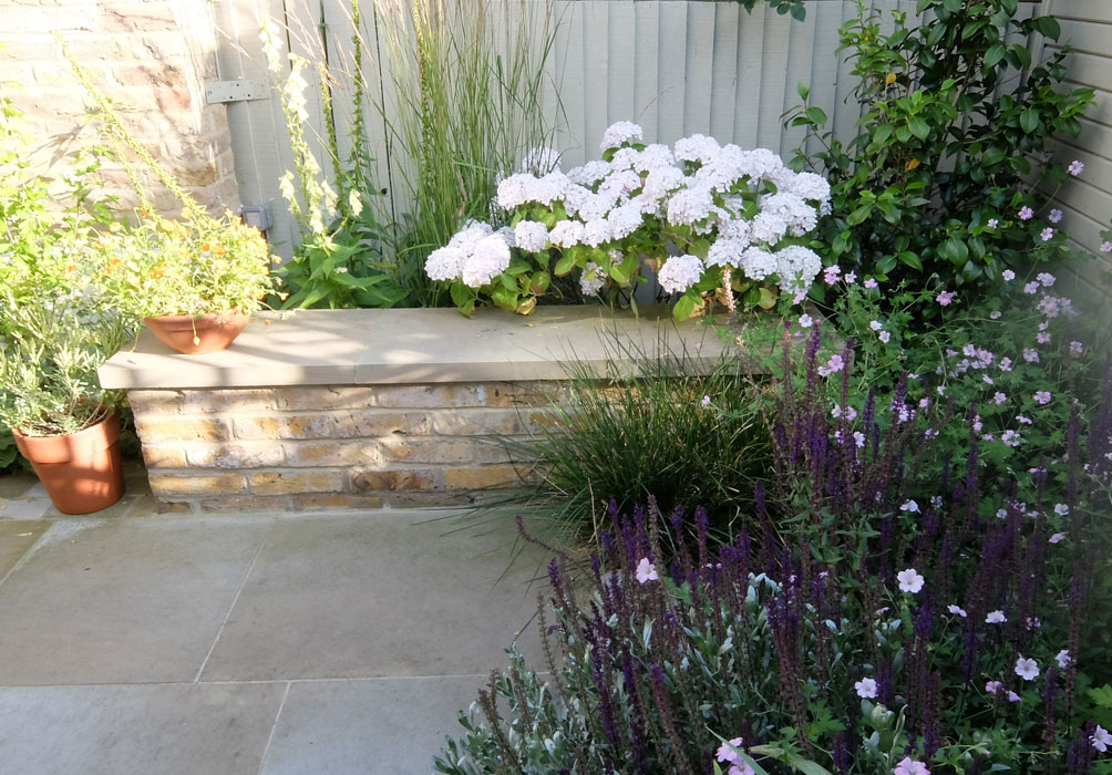 Stone garden bench and planting